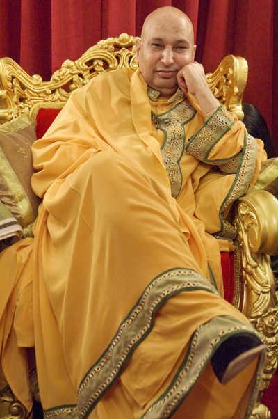 Guruji seated in a golden chair